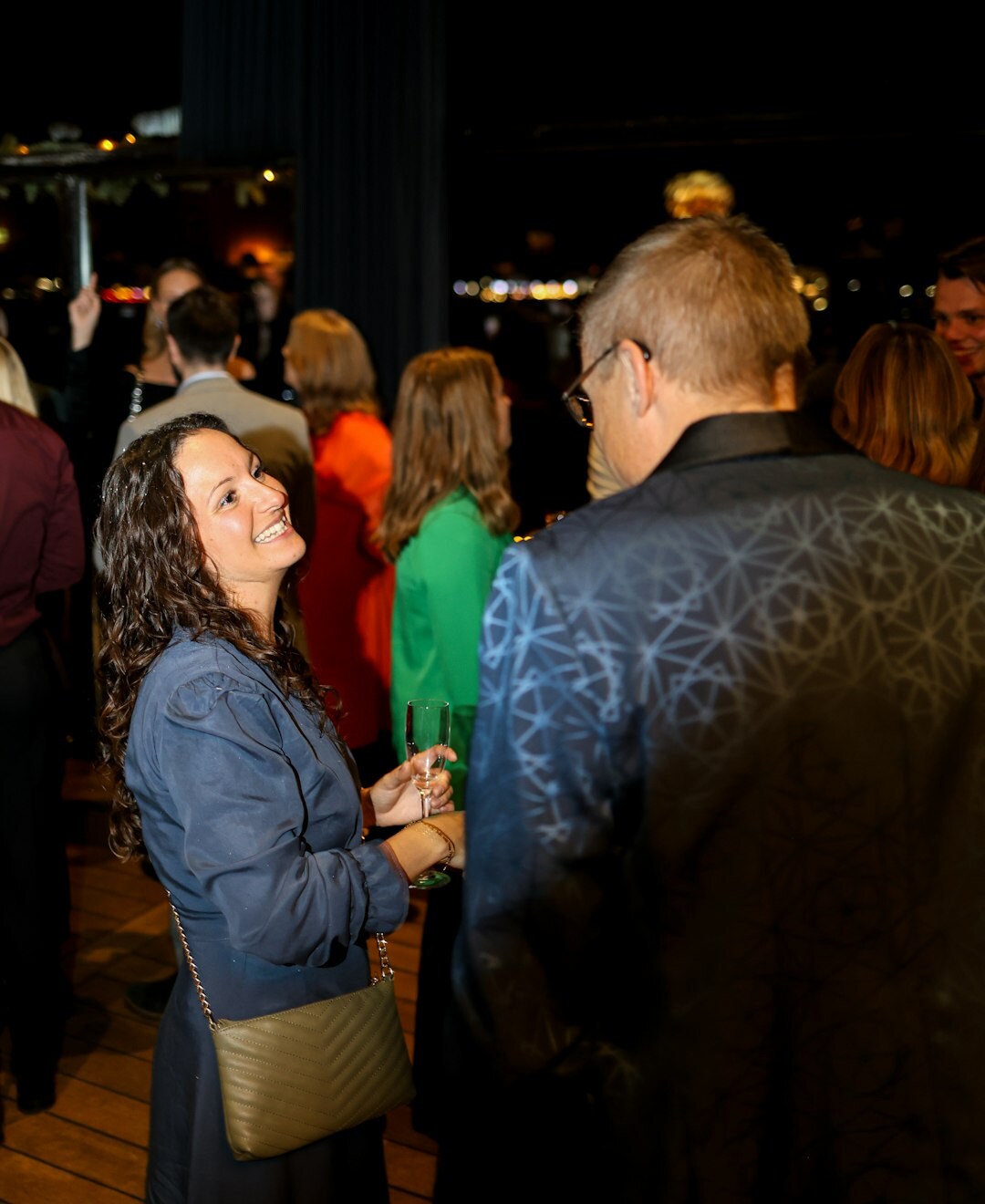 Close-up of two business professionals shaking hands during a networking event